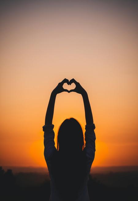 00115-sunset, silhouette, woman, heart shape, hand gesture, warm colors, outdoor, dusk, sky, creative pose, backlit, soft focus, lands.png